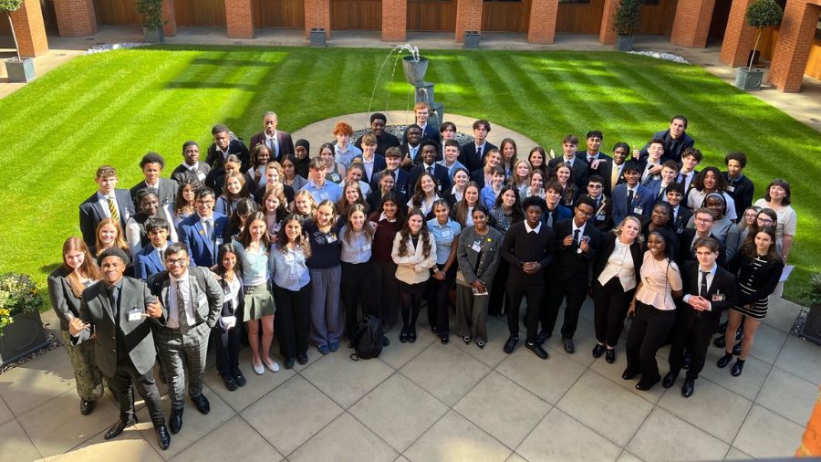 Haberdashers student leaders who are in Year 12 stand together in the courtyard at Haberdashers' Hall